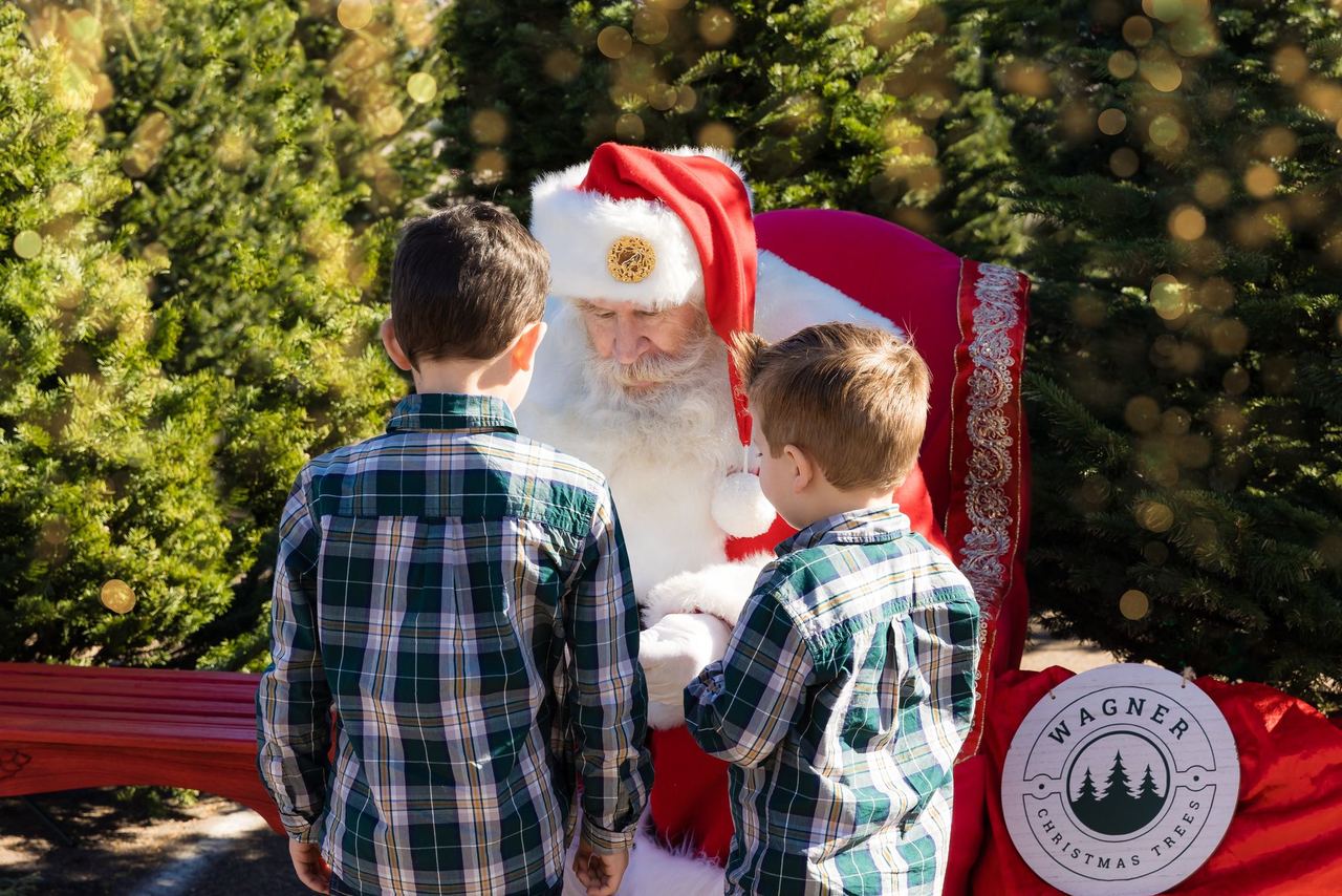 Two kids visiting Santa at the lot